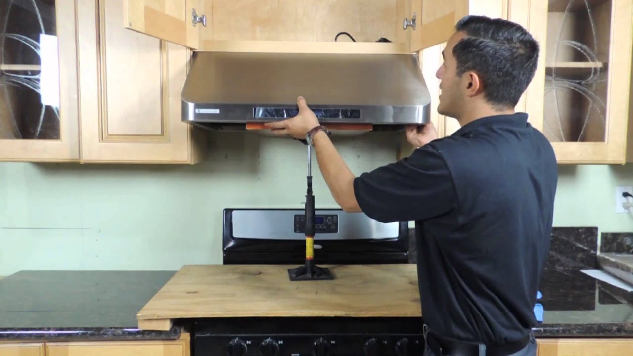 Kitchen hood installer working on commercial extraction system in Kettering